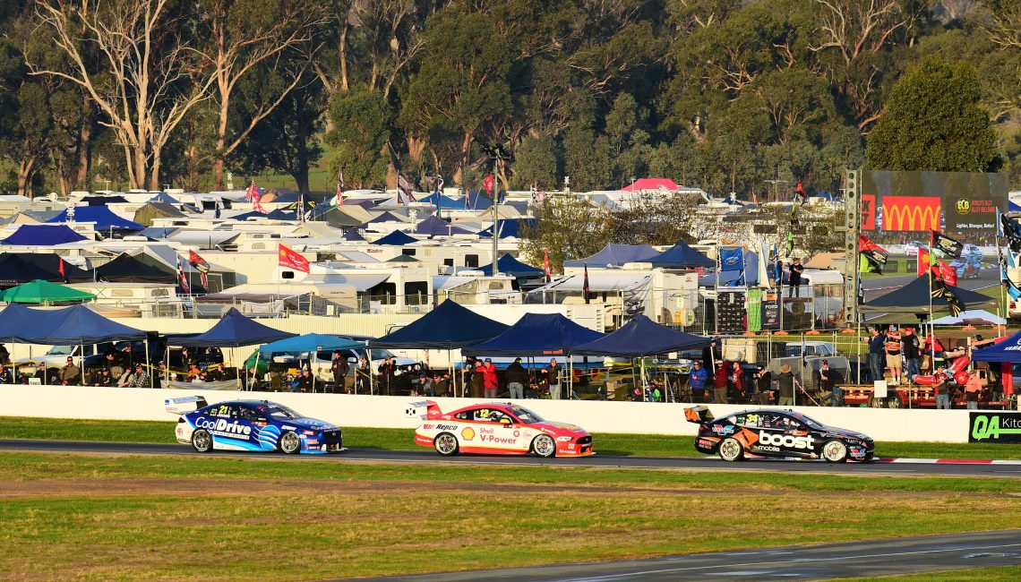 Golding, Coulthard and Jones stream past a jam packed Winton Raceway campsite.